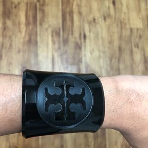 Black Tory Burch cuff bracelet with engraved logo.